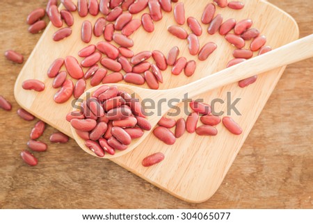Raw red kidney bean on wooden table, stock photo