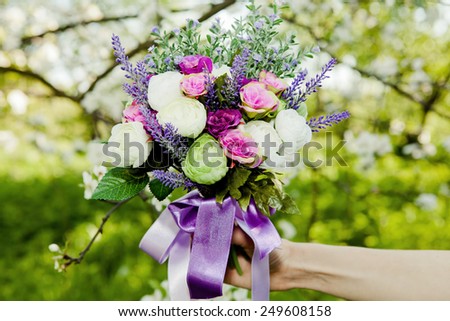 Beautiful bouquet of colorful flowers holding by girl\'s hands