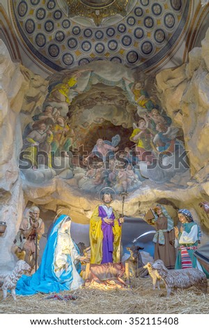 ROME, ITALY - CIRCA DECEMBER 2015 - Christmas nativity scene with baby Jesus, Mary & Joseph in barn with sheep and shepherds, with open Heavens. Life size crib in the church Ara Coeli in Rome.
