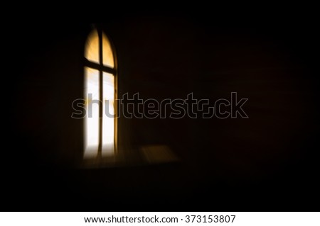Abstract artistic dark blur glowing window with a cross in the darkness, with copy space for text