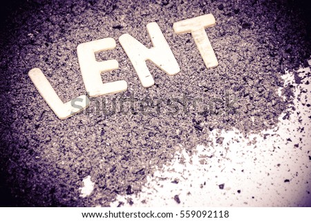 Lent season, written in ashes for the Ash Wednesday and fasting period, Christian religious symbol artistic vintage background