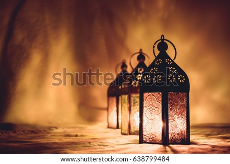 Eid lamps or lanterns for Ramadan and other islamic muslim holidays, with copy space for text. Artistic monotone edit.