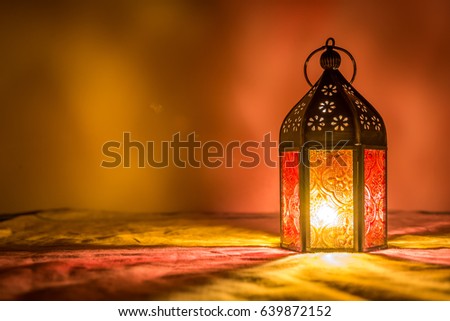Eid orange lamp or lantern for Ramadan and other islamic muslim holidays, with copy space for text.