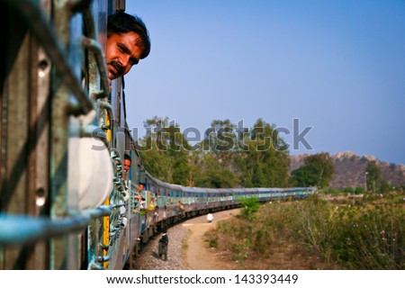 JHANSI, INDIA - MARCH 3: Unidentified man on the train on March 3, 2011 in Jhansi. Indian railway network comprises of 115,000km of track and 7,500 stations.