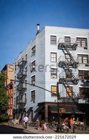 NEW YORK CITY - JUNE 18, 2014: Building with typical fire escapes in Soho, NYC. A fire escape is a special kind of emergency exit usually mounted to the outside of a building.