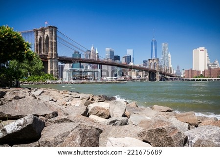 NEW YORK CITY - JUNE 16, 2014: The Brooklyn Bridge & Manhattan seen from Main Street Park. Approximately 4,000 pedestrians and 3,100 cyclists cross this historic bridge each day.