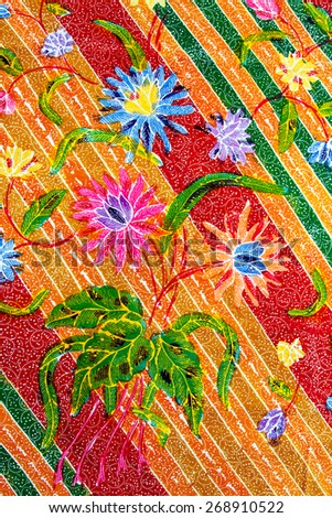 Batik design in Thailand for traditional clothes. Colorful Red Green Blue tone background and flower style.