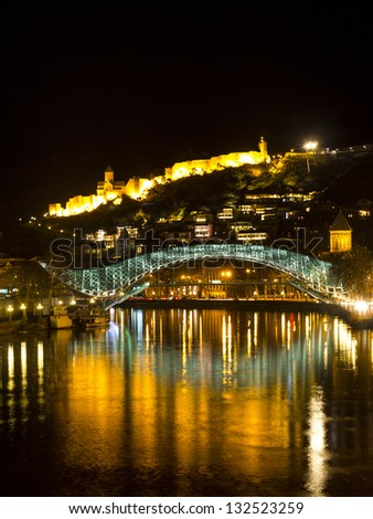 The Bridge of Peace illuminated by night. The bridge stretches over the Kura river and connects the Old Tbilisi with the new district.