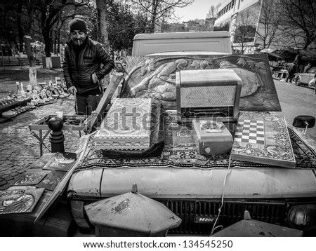 TBILISI, GEORGIA - MARCH 24: Georgian man sells old used items on the Dry Bridge Market Tbilisi on March 24, 2013. The Dry Bridge Market is the city\'s unofficial open-air art and second-hand bazaar.