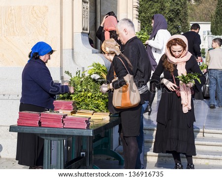TBILISI, GEORGIA - APRIL 27:  People buy palms for the Palm Sunday in front of The Holy Trinity Cathedral of Tbilisi on April 27, 2013.