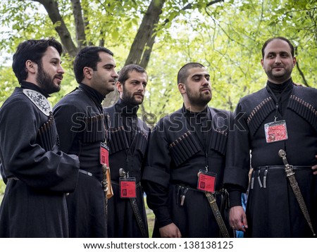 TBILISI, GEORGIA - MAY 11: Men in traditional clothes sing Georgian songs during the annual Young Wine Festival in n the Ethnographic Museum in Tbilisi on May 11, 2013.