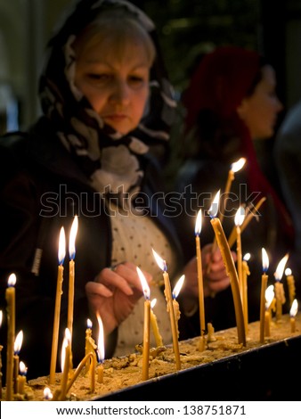 TBILISI, GEORGIA - APRIL 27: Georgians light up candles in the Holy Trinity Cathedral of Tbilisi during service on April 27, 2013. The Cathedral is the main Cathedral of the Georgian Orthodox Church.