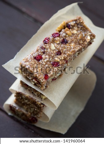 Homemade granola protein bars with peanut butter, honey, nuts and cranberries.