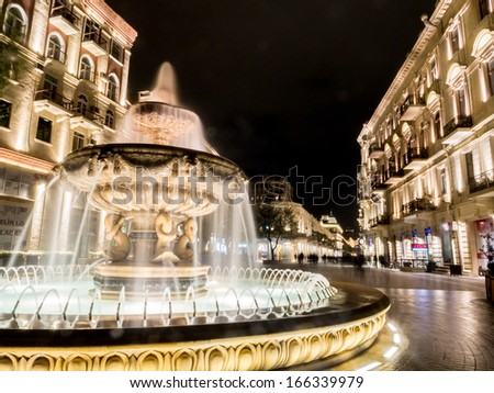 Baku, Azerbaijan - November 22: Fountain At The End Of The Nizami Street In Baku, Azarbaijan, Illuminated By Night On The November 22, 2013. The Street Is Known For Its Exclusive Stores.