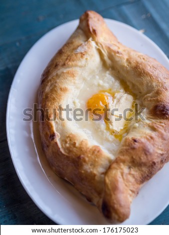Georgian cuisine: ajaruli khachapuri - Georgian bread with egg and cottage cheese.