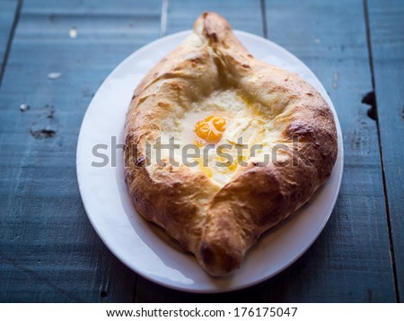 Georgian cuisine: ajaruli khachapuri - Georgian bread with egg and cottage cheese.
