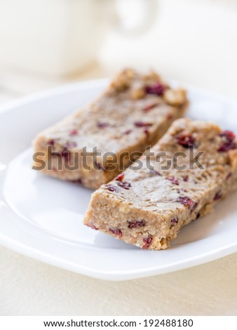 Natural homemade protein bars with peanut butter, honey, oats, nuts and cranberries.