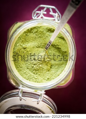 Moringa powder in a glass jar.