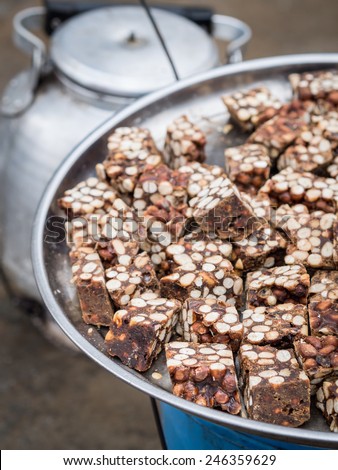 Kashata, Tanzanian peanut brittle traditionally sold by street vendors along with black coffee.