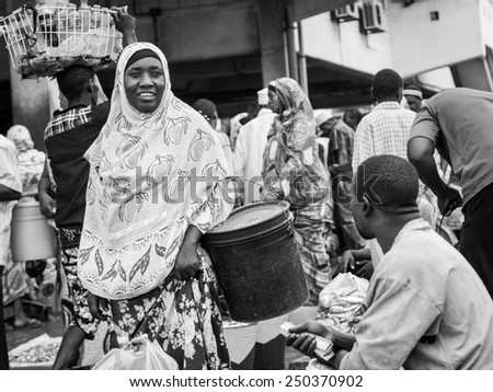 DAR ES SALAAM, TANZANIA - JANUARY 15, 2015: Local people in the fish market in Dar es Salaam in East Africa on Sunday. Black and white.