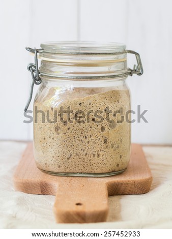 Active rye sourdough starter in a jar.