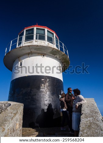 CAPE POINT, SOUTH AFRICA - FEBRUARY 15, 2015: Tourists visit the old lighthouse at the top of Cape Point in South Africa.