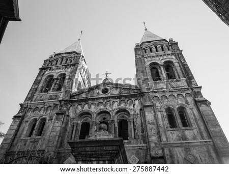 Wide angle photo of the front and the towers of the Roman St. Joseph\'s Catholic Cathedral in Stone Town, Zanzibar, Tanzania, East Africa, at sunset. Horizontal orientation, black and white.