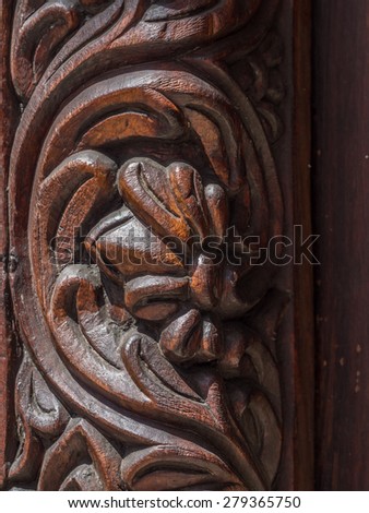 Vertical close up photo of floral ornaments on old traditional wooden carved door in Stone Town, Zanzibar, Tanzania, East Africa.