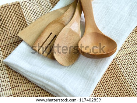 Wooden cooking utensils on wood background