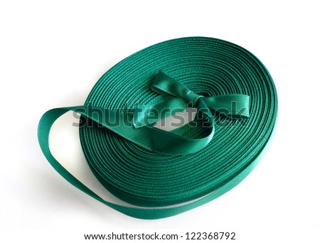 Green ribbon roll on a white background