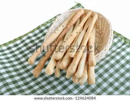 bread sticks with basket on green cloth