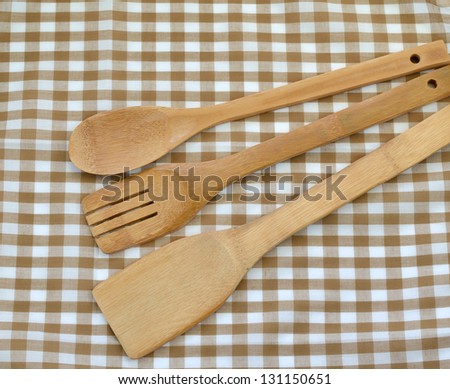 Wooden cooking utensils on brown cloth