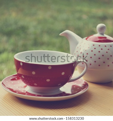 Red polka dot kettle and cup of tea retro