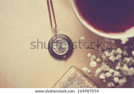 Old blank paper and old watch with cup of tea