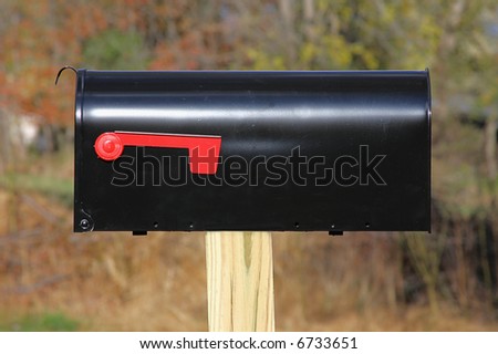 Black mail box on a post with the flag down