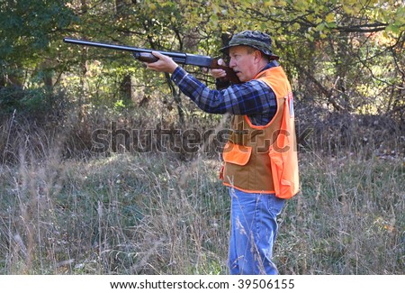 Man hunting shooting a shotgun