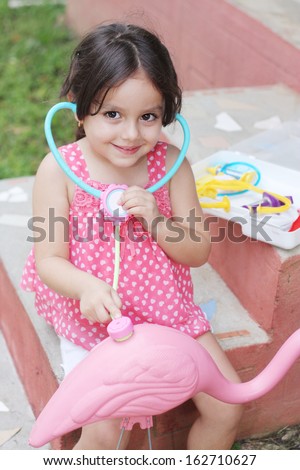 Adorable Little girl Playing Doctor With Stethoscope out door