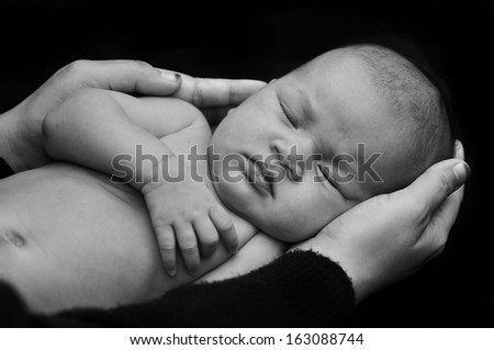 Mom Hand hold The Baby in Black Background