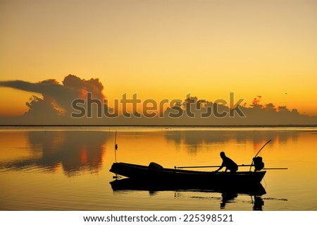 Silhouette of Fisherman going Work in Warm Tone