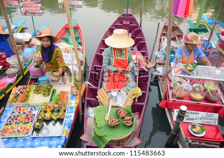 HATYAI, THAILAND - FEB 12: A woman makes Thai food at Khlong Hae Floating Market on February 12, 2012 in Hatyai, Thailand. Its popular for traditional style Thai food and old Thai culture.