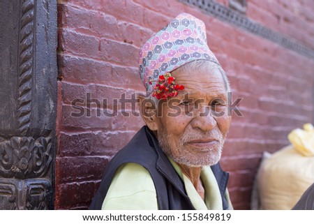 NEPAL, BHAKTAPUR, APRIL 30: Portrait of of an unidentified and old man with a flower next to to his ear living in Bhaktapur, the most beautiful city within the Kathmandu Valley, April 30, 2010, Nepal