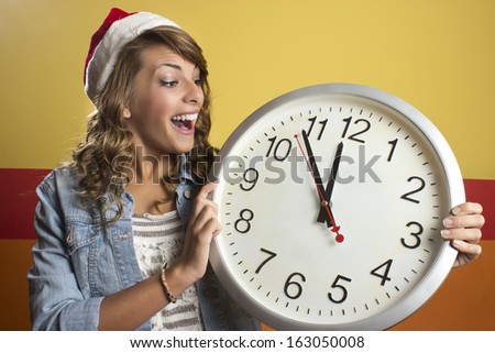 Smiling woman with clock showing 12