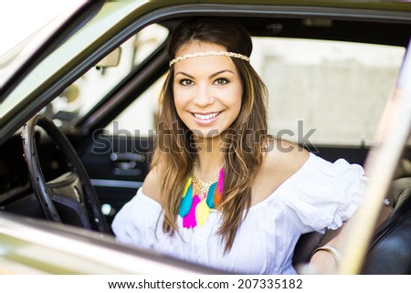 Beautiful lady sitting in a retro car