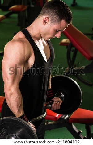 Man with weight training equipment on sport gym club