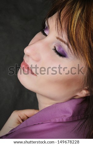 young emotional girl in a purple shirt with a short haircut