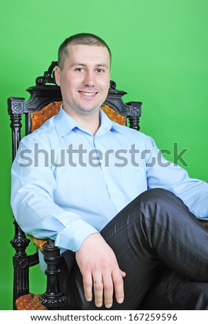 young business man in a blue shirt in the chair