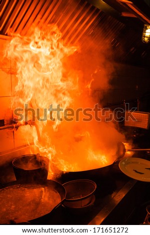 Fire gas burn is cooking on iron pan,stir fire very hot