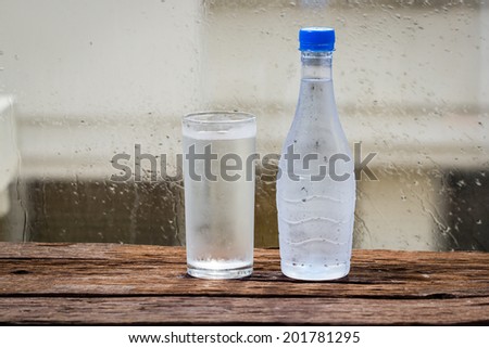 Cold water in bottle on wood table