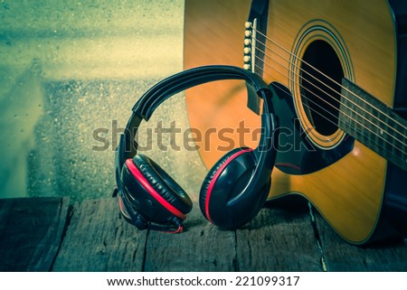 Headphones with acoustic guitar. vintage retro