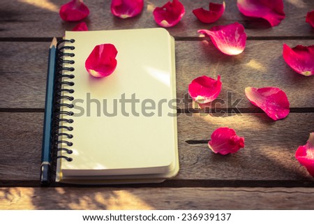 Flower with notebook on desk